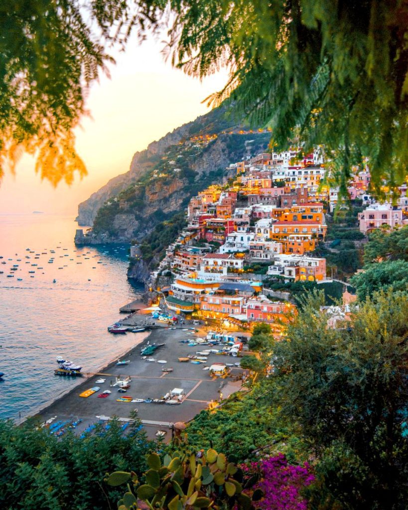 El Secreto de la Costa Amalfitana: Viaje de Lujo más allá de Positano Panorámica de Positano, Italia, un pueblo colorido en el acantilado, con vistas al mar y la playa.