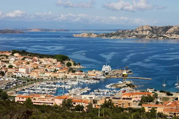 Vista aérea sofisticada de la bahía de Cerdeña con aguas turquesas y embarcaciones exclusivas